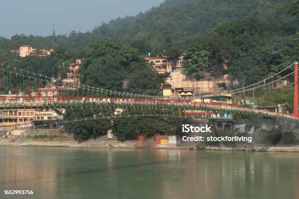 Beautiful View Of Ram Jhula With Ganga River And Mountains In Rishikesh Uttarakhand Stock Photo - Download Image Now