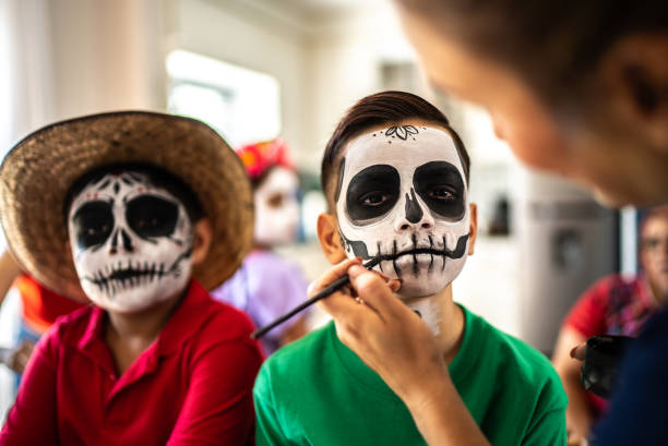 istock Boys getting face makeup as a sugar skull for day of the dead 1652997161