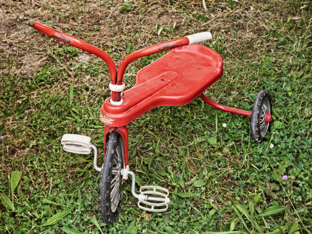 istock vintage toy, red old tricycle on the grass 1653003251