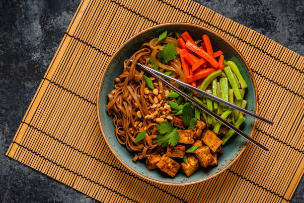 istock Soba noodles with vegetables and fried tofu in a bowl. 1653007619