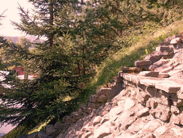 A sloping stone mountain slope with stone steps. Stone stairs to the mountain.