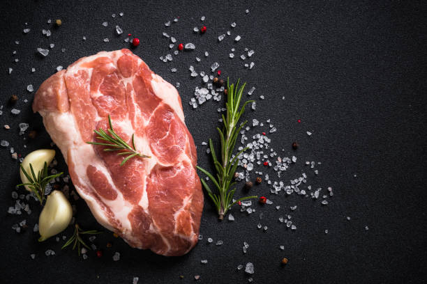 istock Fresh steak with herbs and spices at black background. 1653019096