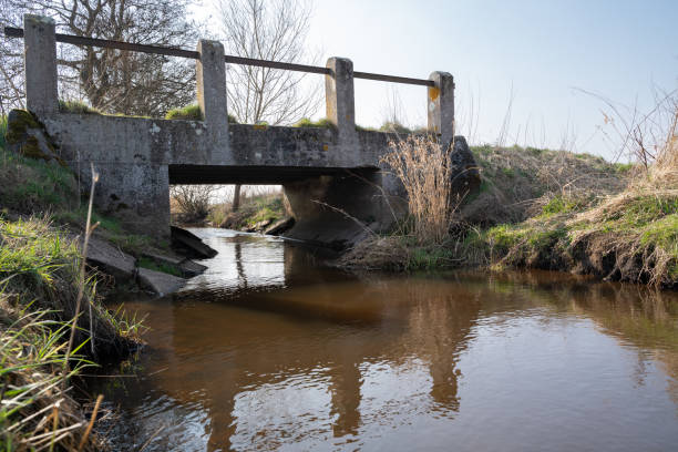 istock Small concrete bridge by the water stream 1653023039