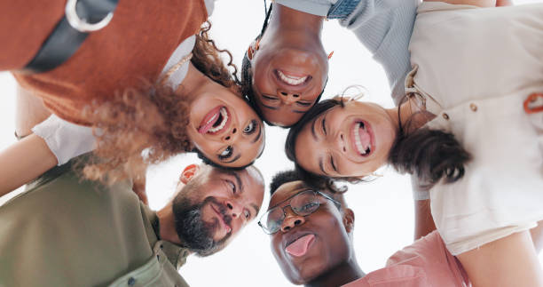 istock Diversity, teamwork and comic with business people from bottom for community, funny and support. Target, happy and solidarity with employee and funny face for collaboration, success and achievement 1653030782