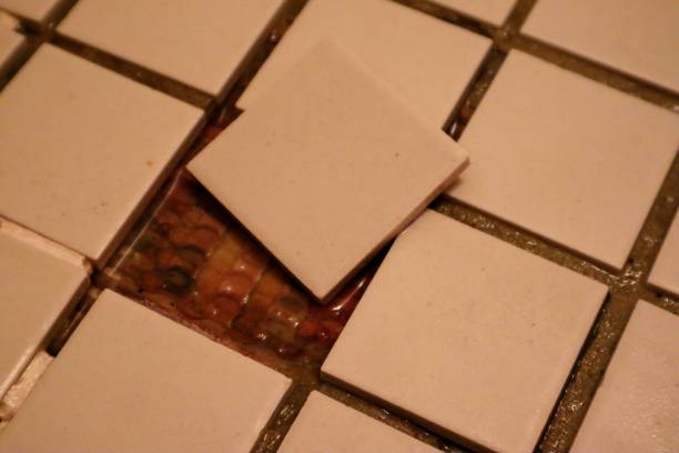 istock Bathroom floor with peeling tiles 1653044011