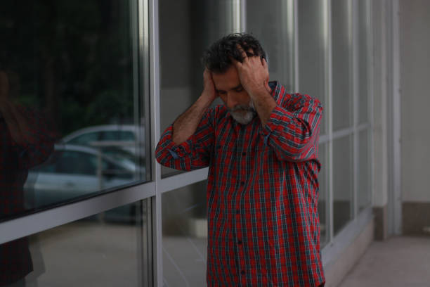 dramatic portrait of middle aged sad and depressed man in pain feeling stressed and frustrated suffering depression problem and anxiety crisis looking desperate and gloomy