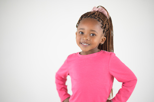 Cute and Confident Toddler Girl with braided hair studio portrait