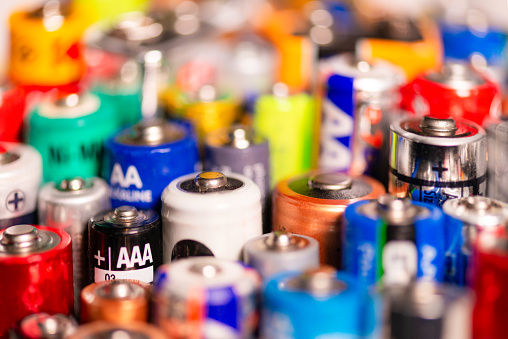 A large variety of battery types and brands together. Shallow depth of field.