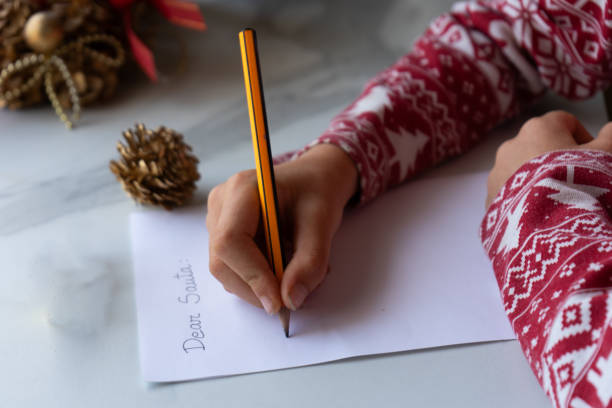 istock Boy writing the letter to Santa Claus 1653068723