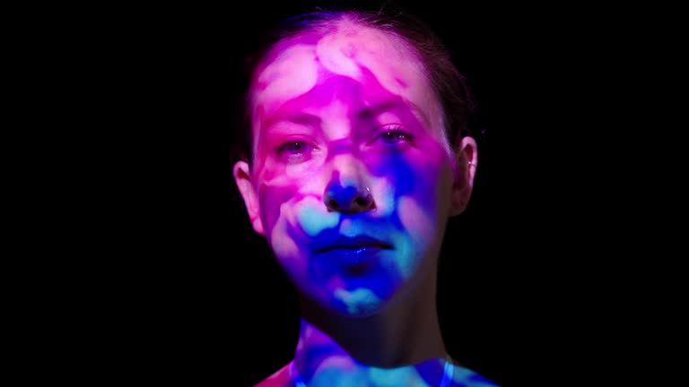 Colorful lights on a woman's face