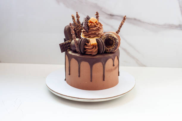istock Elegant chocolate birthday cake with chocolate ganache, cupcake, popsicles, sweets, chocolate bars, waffles, donuts and cookies 1653076943