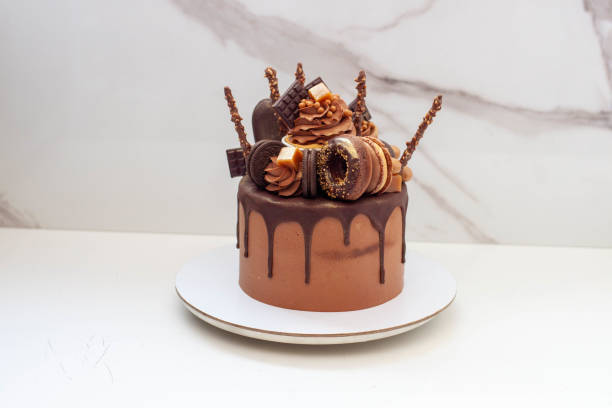 istock Elegant chocolate birthday cake with chocolate ganache, cupcake, popsicles, sweets, chocolate bars, waffles, donuts and cookies 1653076953
