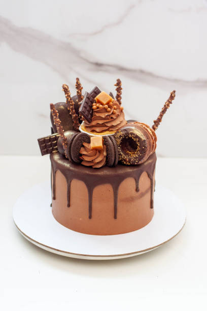 istock Elegant chocolate birthday cake with chocolate ganache, cupcake, popsicles, sweets, chocolate bars, waffles, donuts and cookies 1653076957