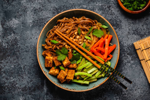 istock Soba noodles with vegetables and fried tofu in a bowl. 1653104362