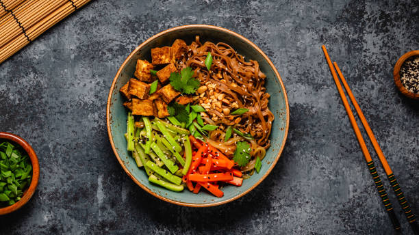 istock Soba noodles with vegetables and fried tofu in a bowl. 1653104871
