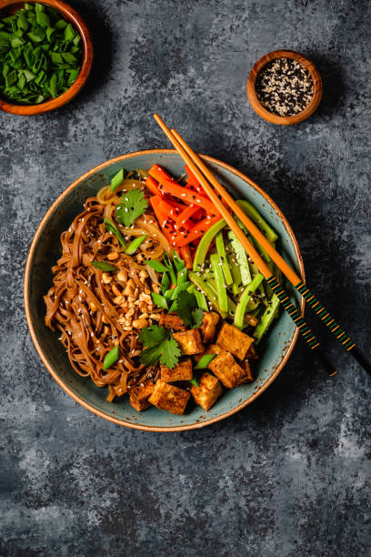 istock Soba noodles with vegetables and fried tofu in a bowl. 1653104882