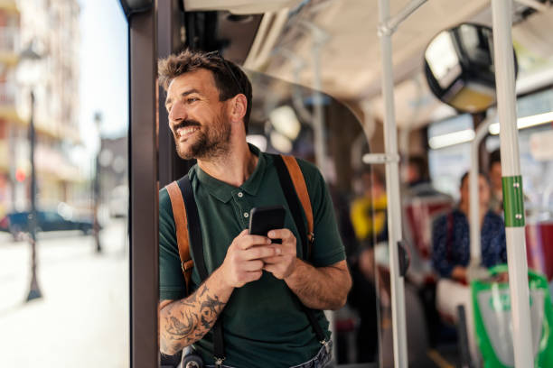 istock An urban commuter is standing in a public bus and looking through the window while typing on the phone. 1653109292