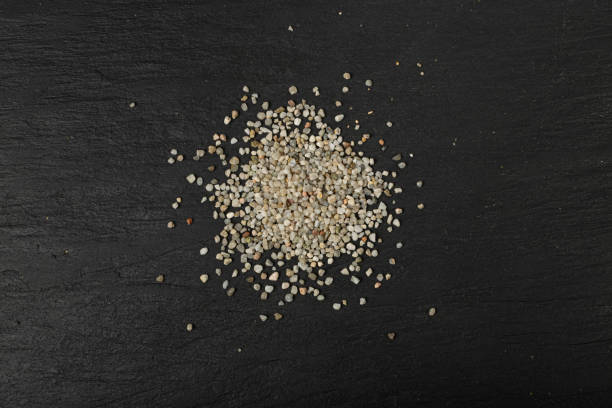 istock Crushed Quartz Pile, White Stone Pieces, Grit Sand, Decorative Rocks Texture on Black Background 1653109832