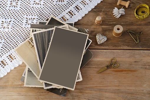 mocap retro, old family photographs, pictures, home archive documents on vintage wooden table, lace doily, concept of family tree, genealogy, memories, memory of ancestors, family tree, nostalgia