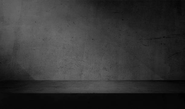 istock minimal abstract dark black concrete background with light for product presentation. shadow and light from windows on rustic plaster wall. grey studio backdrop. 1653133847