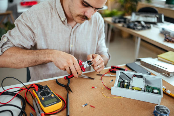 istock Repairman repairing components of electronic device 1653145550