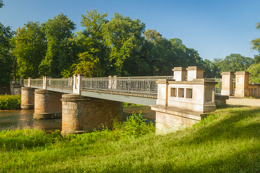 Double Bridge on the Lusatian Neisse River in  Muskauer Park Poland-Germany Border, sunlit in summer