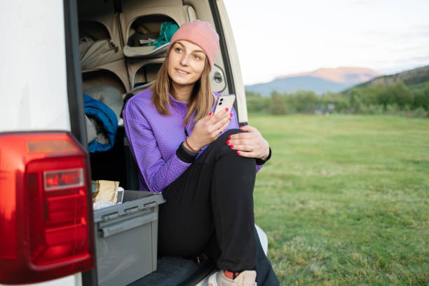 istock Beautiful girl relaxing in her van while camping 1653147212