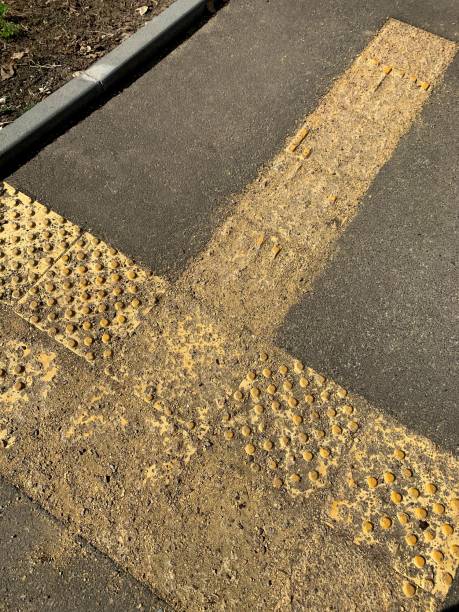 istock Weathered tactile tiles for the blind on the sidewalk. 1653175029