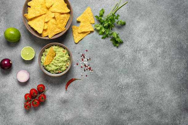 istock Guacamole with nachos on a gray rustic background. Mexican food. Top view, flat lay, copy space. 1653215487