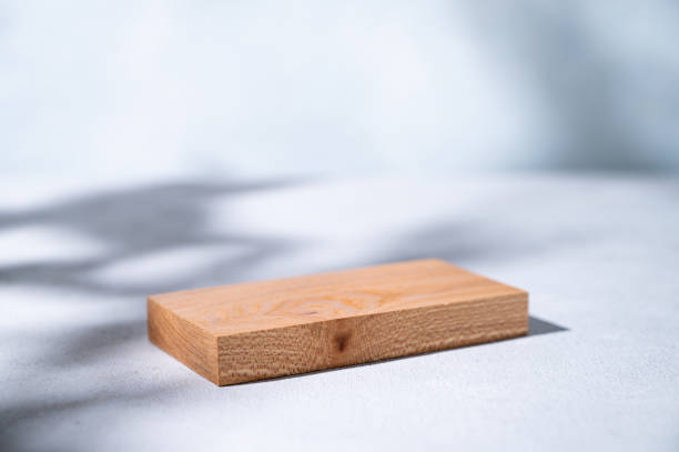 istock Wooden board empty for product demonstration or mock-up with shadows on a blue background. Trendy neutral aesthetic rectangular stand for beauty and cosmetics scene. 1653241742
