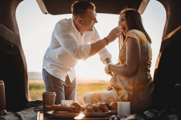 istock Future Parents Having fun on a car picnic 1653330014