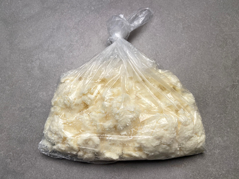 Curd cheese in a transparent plastic bag