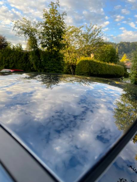istock Dents from hailstones on metallic blue car roof 1653366337