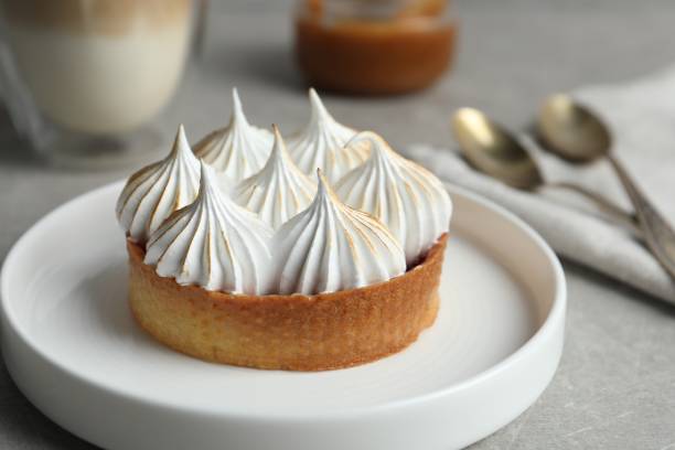 istock Tartlet with meringue on grey table, closeup. Delicious dessert 1653373638