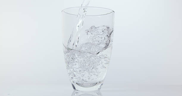istock Water being poured into Glass against White Background 1653378042