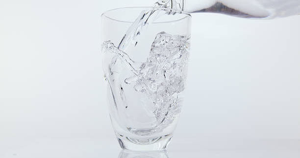 istock Water being poured into Glass against White Background 1653378043
