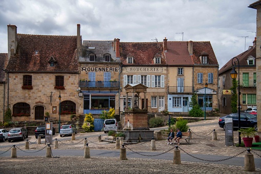 Souvigny, France - August 28, 2023: view of the central square with old shop facades