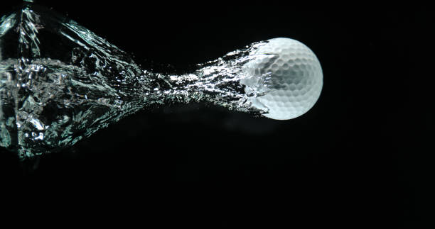 istock Golf's Ball Falling into Water against Black background 1653389500