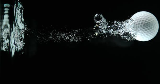 istock Golf's Ball Falling into Water against Black background 1653389504