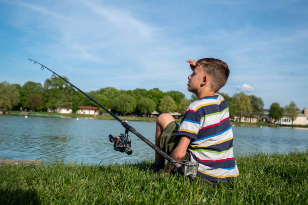 istock a boy is fishing 1653390553