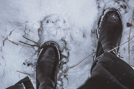Black shoes on white snow.