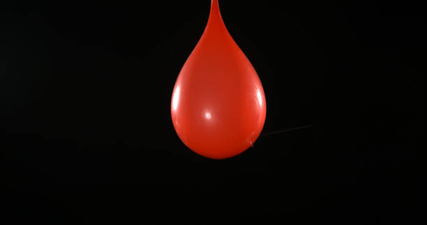 istock Shot Breaking Water Filled Red Balloon 1653400000