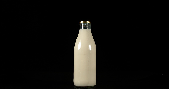 Bottle of Milk against Black Background
