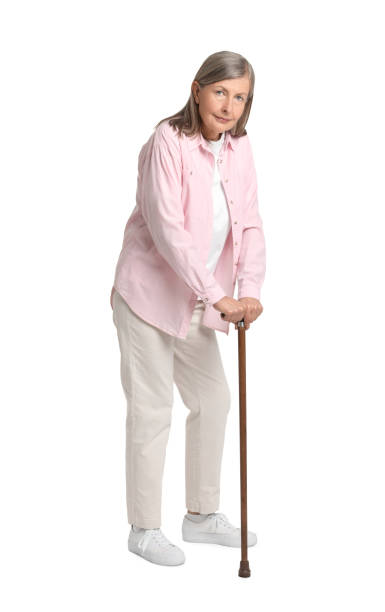 istock Senior woman with walking cane on white background 1653453386