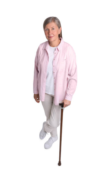 istock Senior woman with walking cane on white background, above view 1653454475