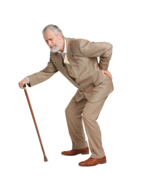 istock Senior man with walking cane suffering from back pain on white background 1653455015