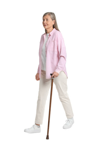 istock Senior woman with walking cane on white background 1653455544