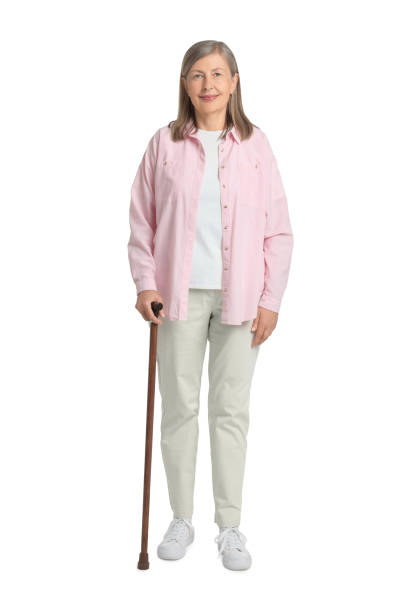 istock Senior woman with walking cane on white background 1653456098