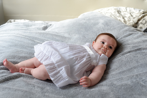 baby lying on the bed in a room