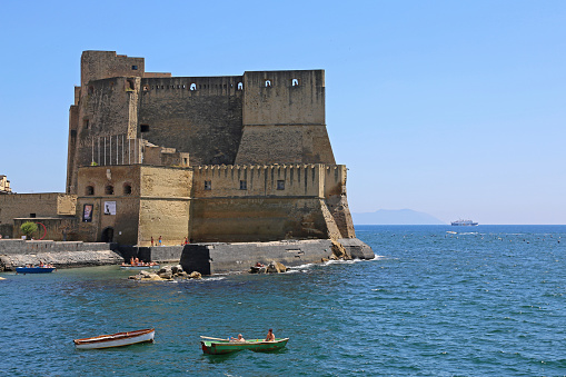 Naples, Italy - June 22, 2014: Castel dell Ovo Fortification Landmark at Tyrrhenian Sea Front Summer Day.